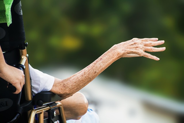 An outstretched arm from a wheelchair