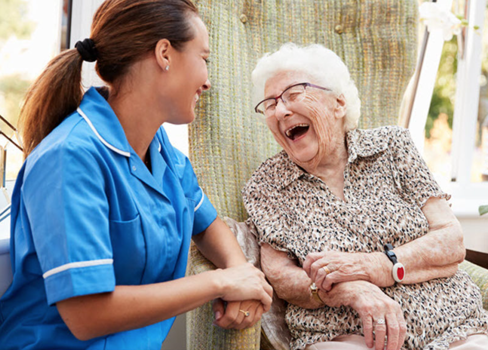 A resident laughing with nurse