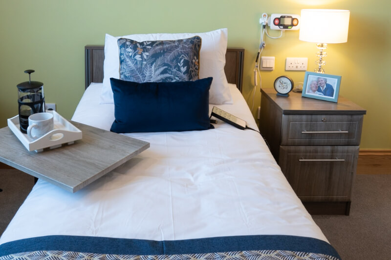 Blue bed with bedside table