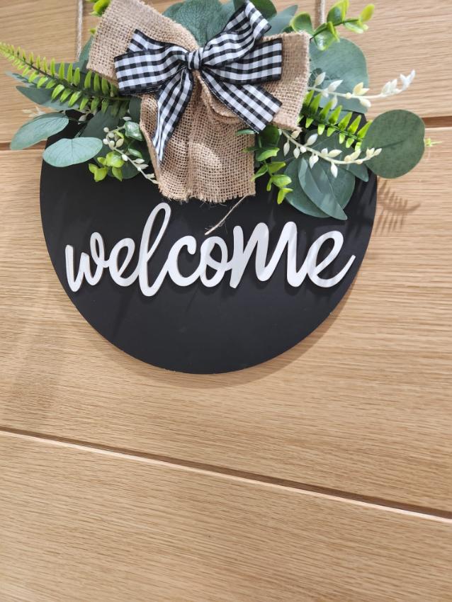 A welcome sign on door.