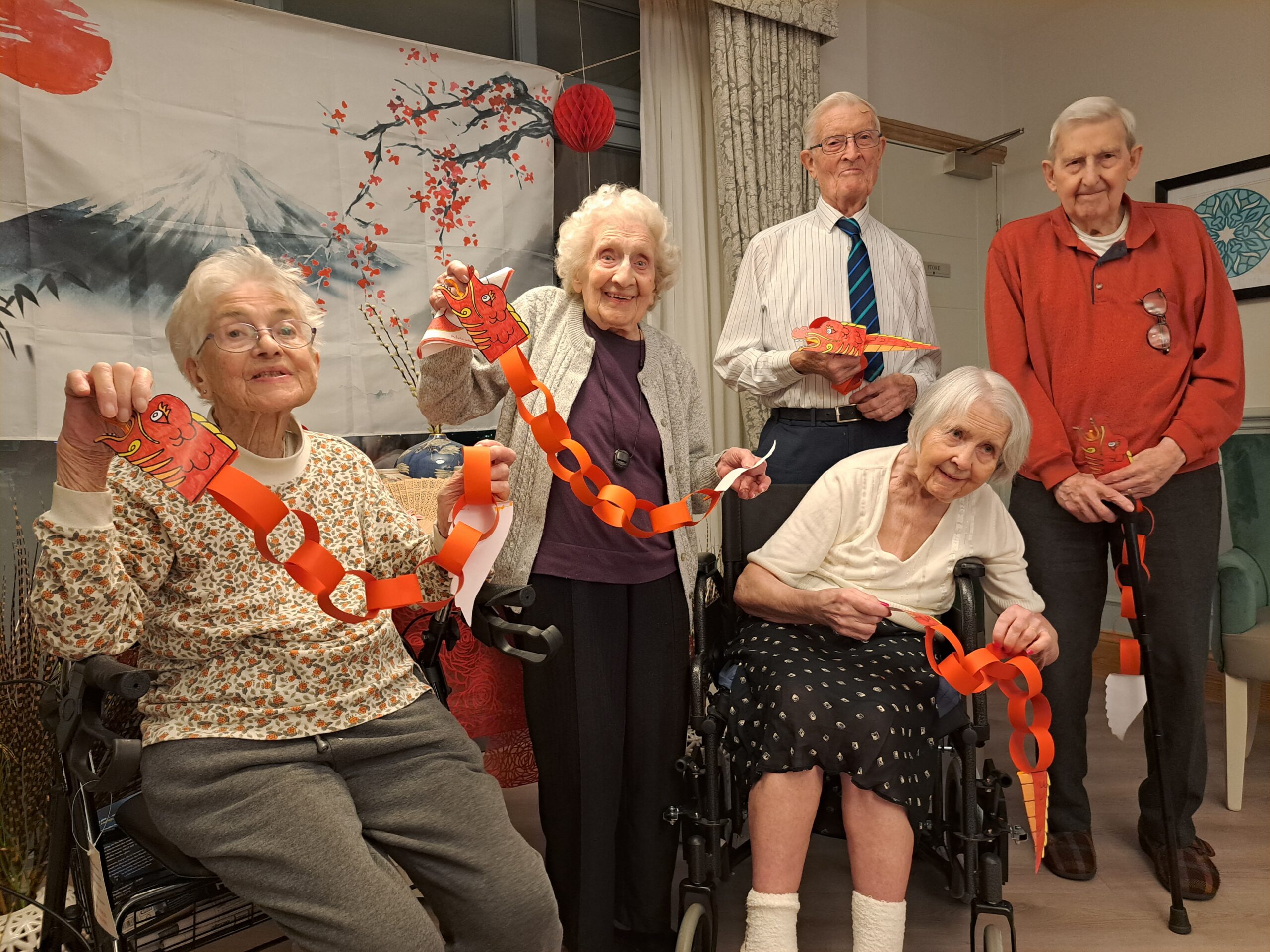 Three female residents and two male residents celebrating chinese new year.