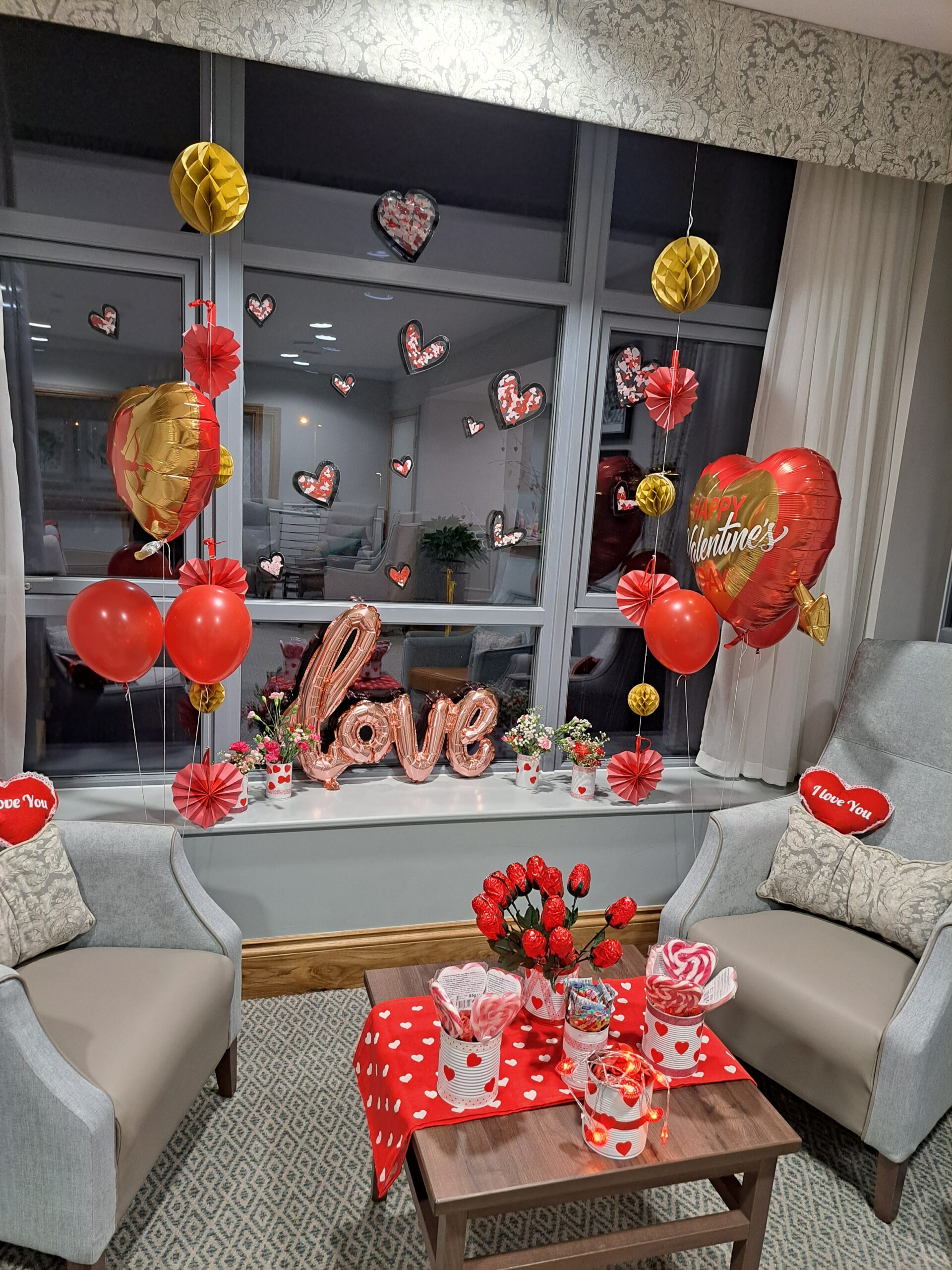 Valentines day display with balloons and chocolate flowers.