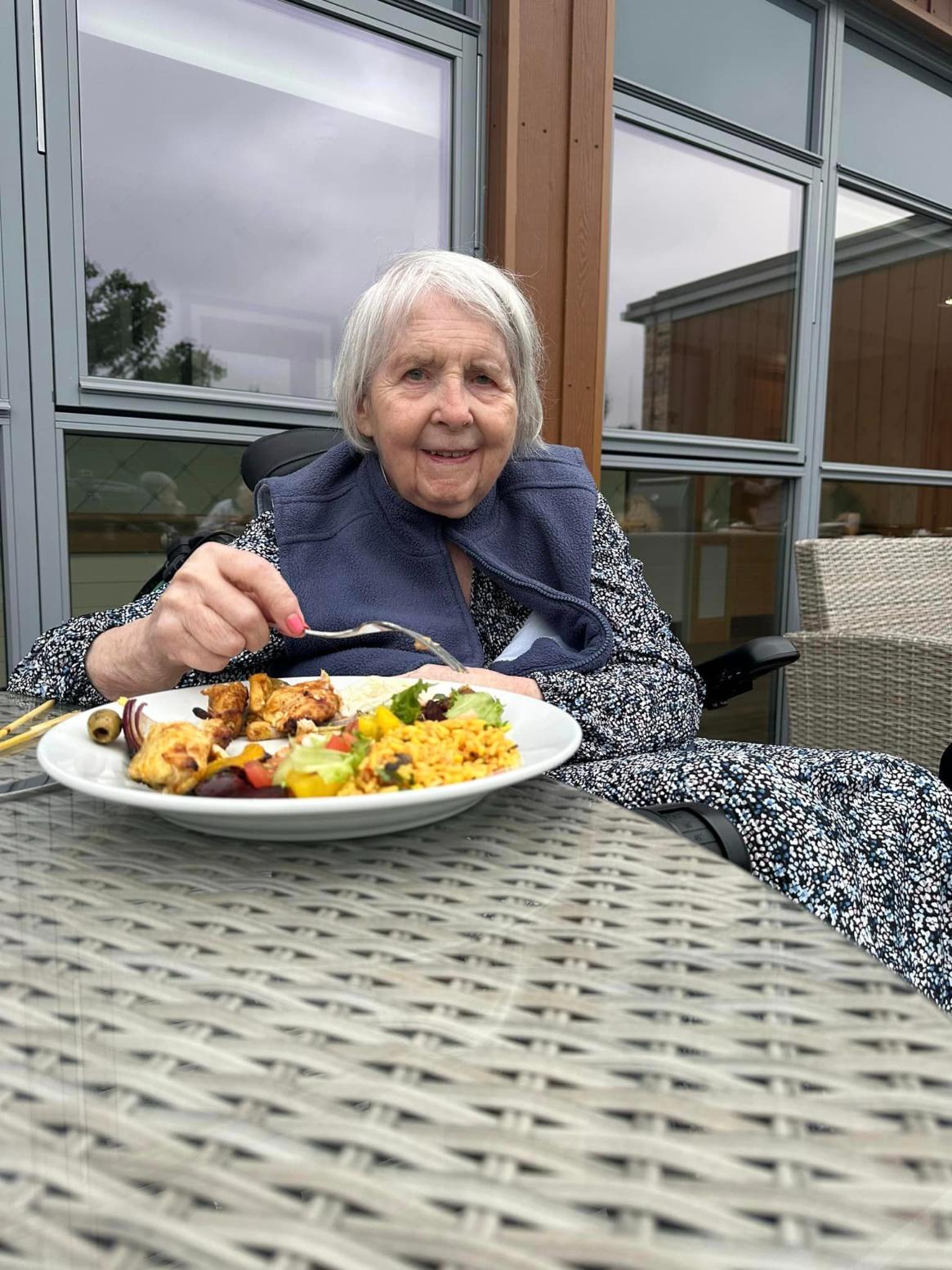 A resident enjoying lunch outside