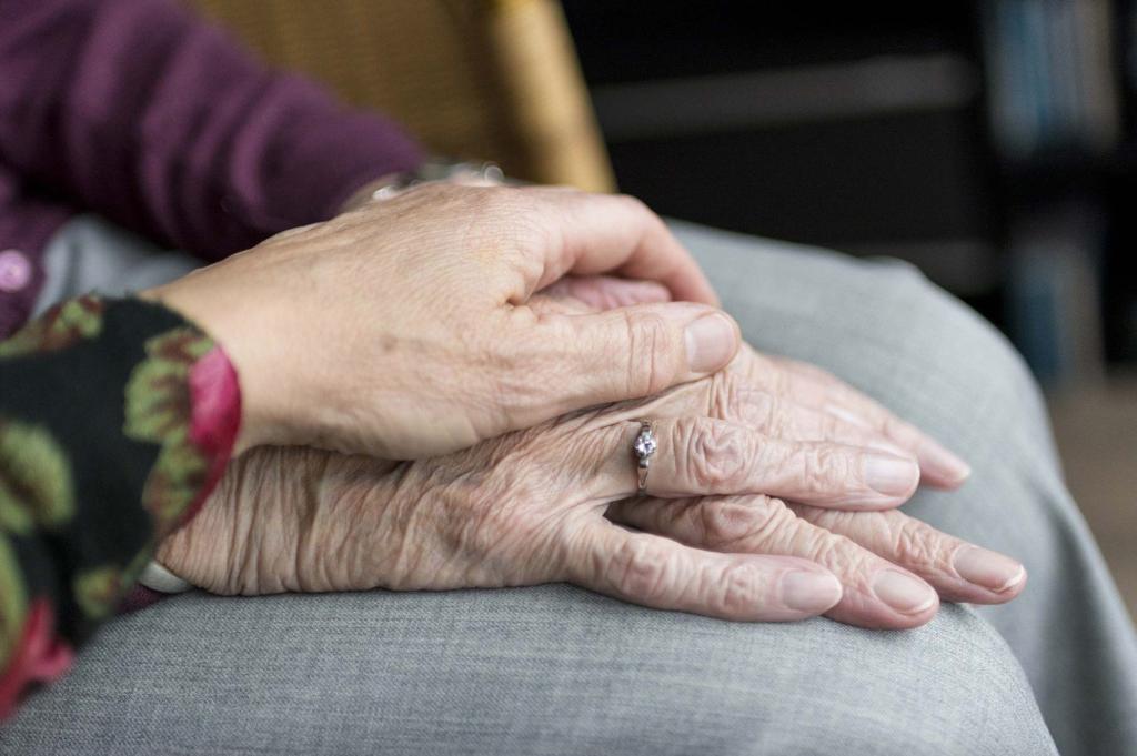 Young and old holding hands