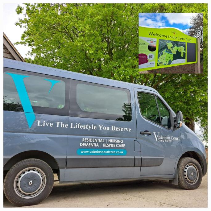 A grey 'Valerian Court' mini van with branding and a email of a sign with a map with the text 'Welcome to the Earth Trust'.