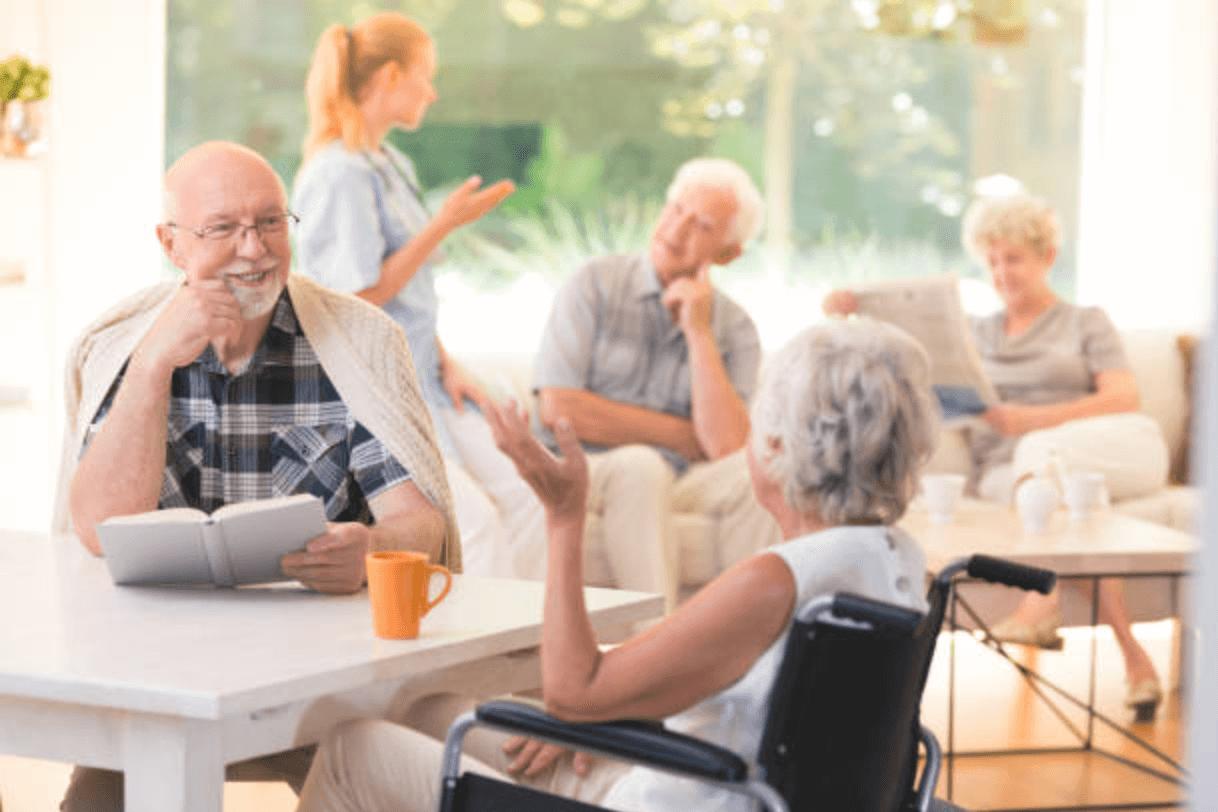 Residents chatting in a bright sun room