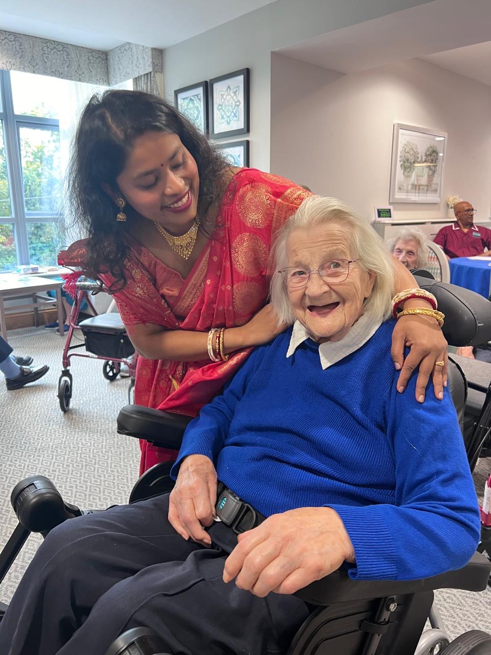 resident smiling and spending time with carer