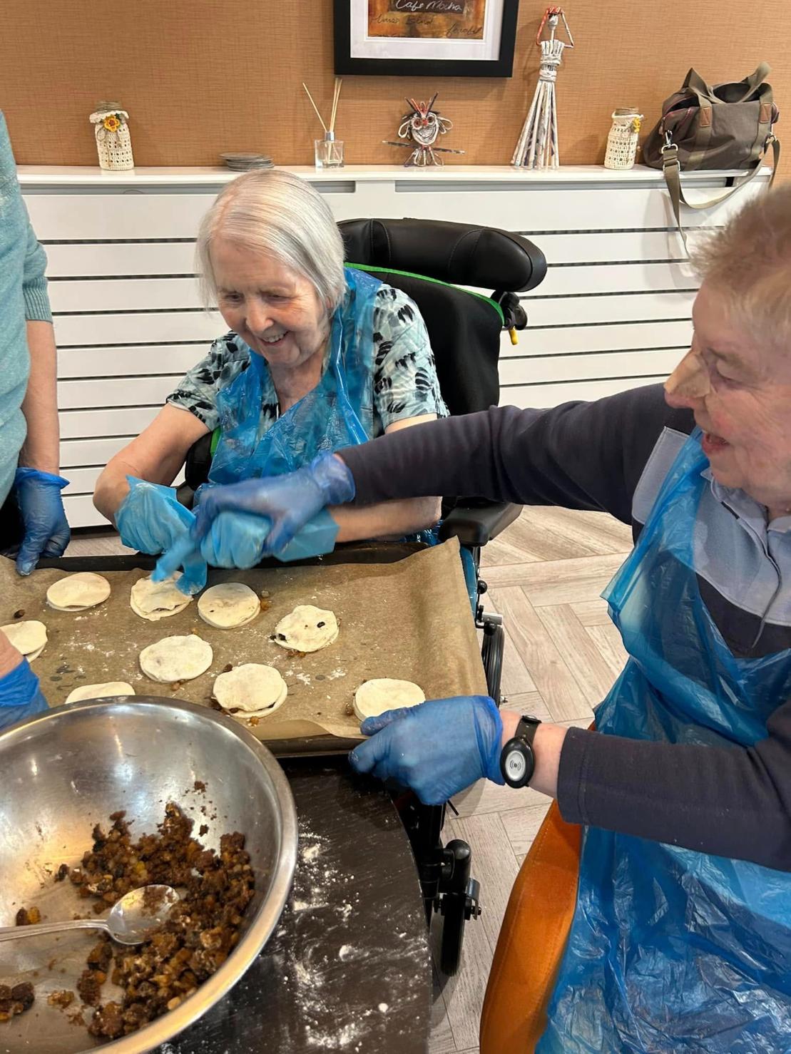 residents smiling whilst baking together