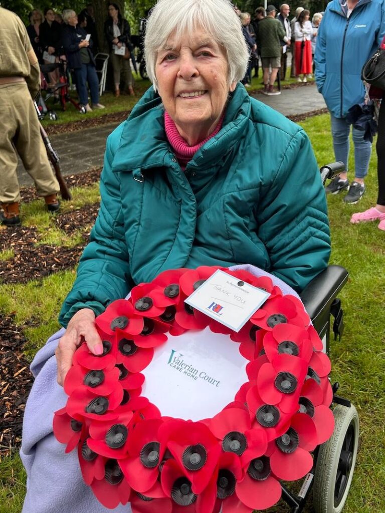 one of our residents with a poppy wreath