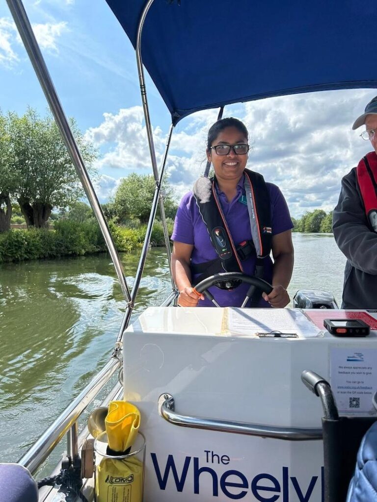 one of our team driving the boat on the Thames