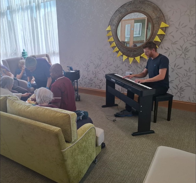 entertainer playing piano for residents