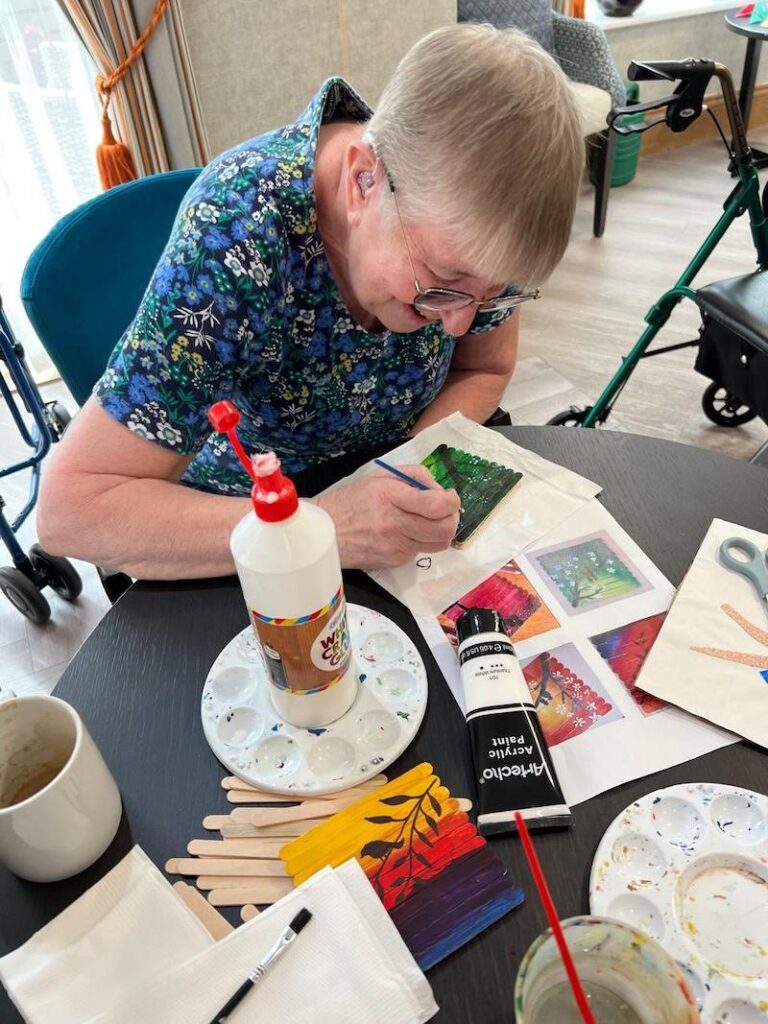 resident doing arts and crafts