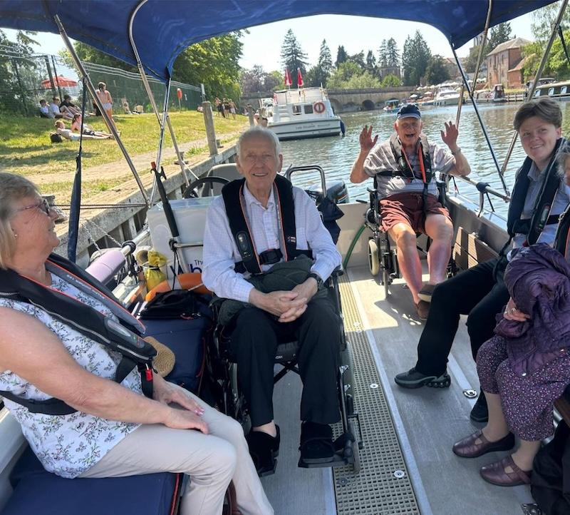 a few of our residents smiling while on a boat trip
