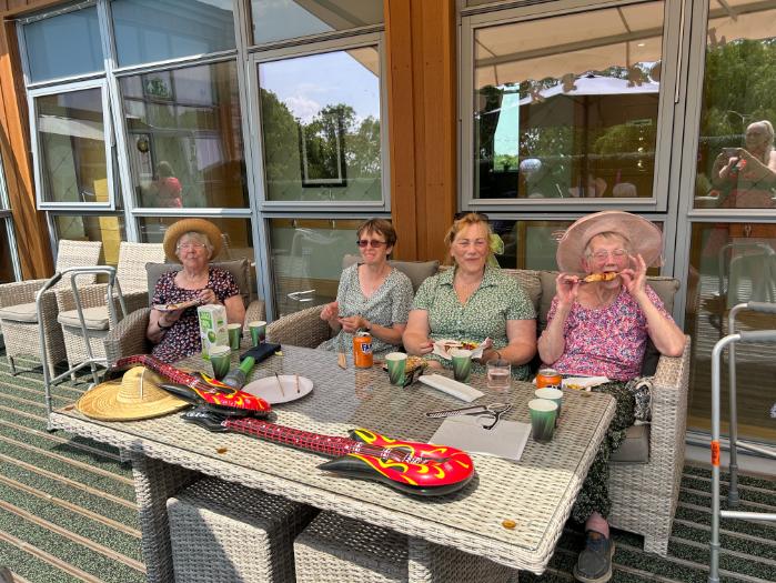 residents outside sat at a table