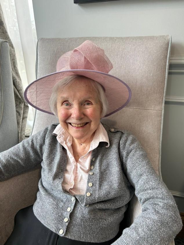 older lady sat in a chair smiling