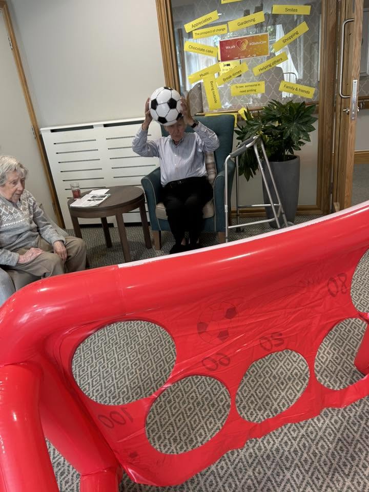 residents with a football in the lounge