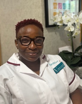 lady in a white care uniform posing for staff photo