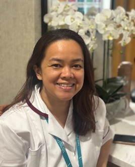 lady in a white care uniform posing for staff photo