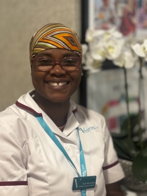 lady in a white care uniform posing for staff photo
