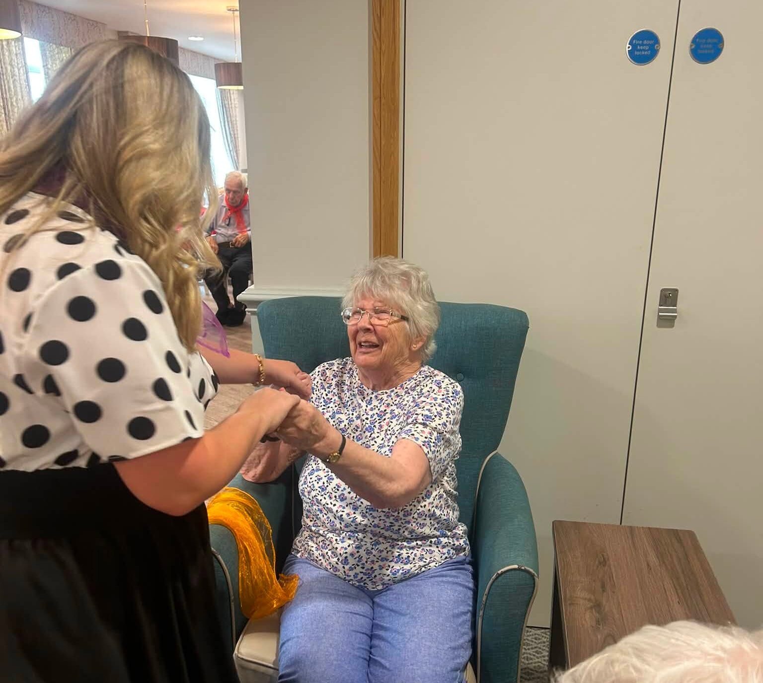 woman holding an older ladies hand