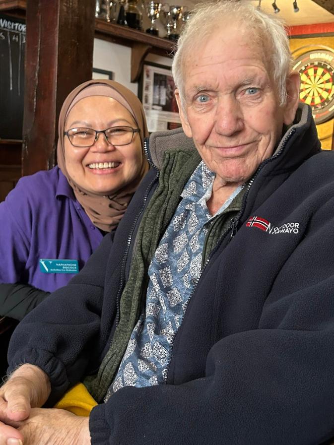 resident and staff member smiling